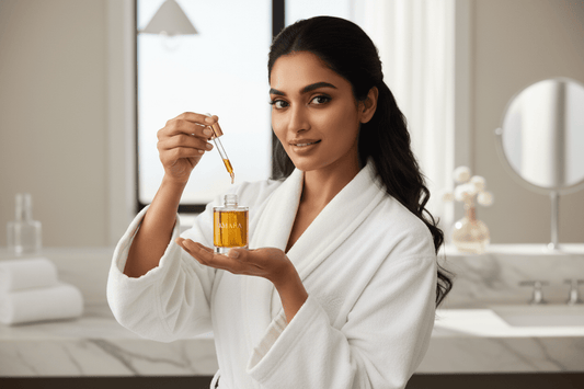 a women in white bath robe with an opened bottle of oil