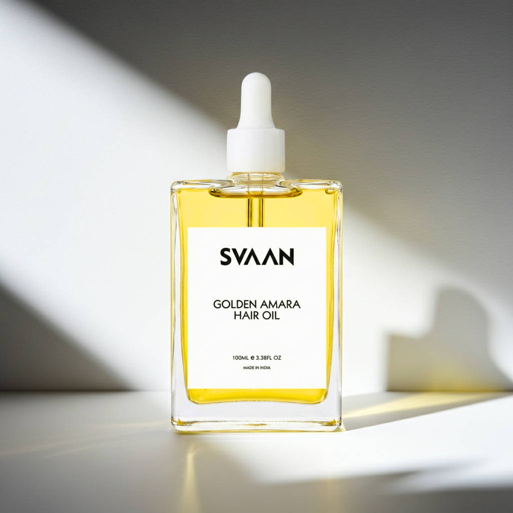 svaan golden amara hair oil is displayed against a white background with shadows