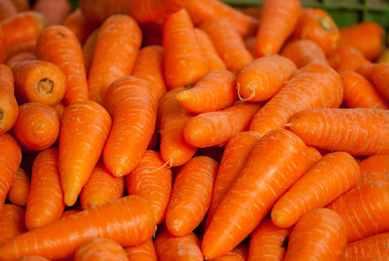 Close-up of a pile of orange carrots, a main ingredient of golden amara hair oil