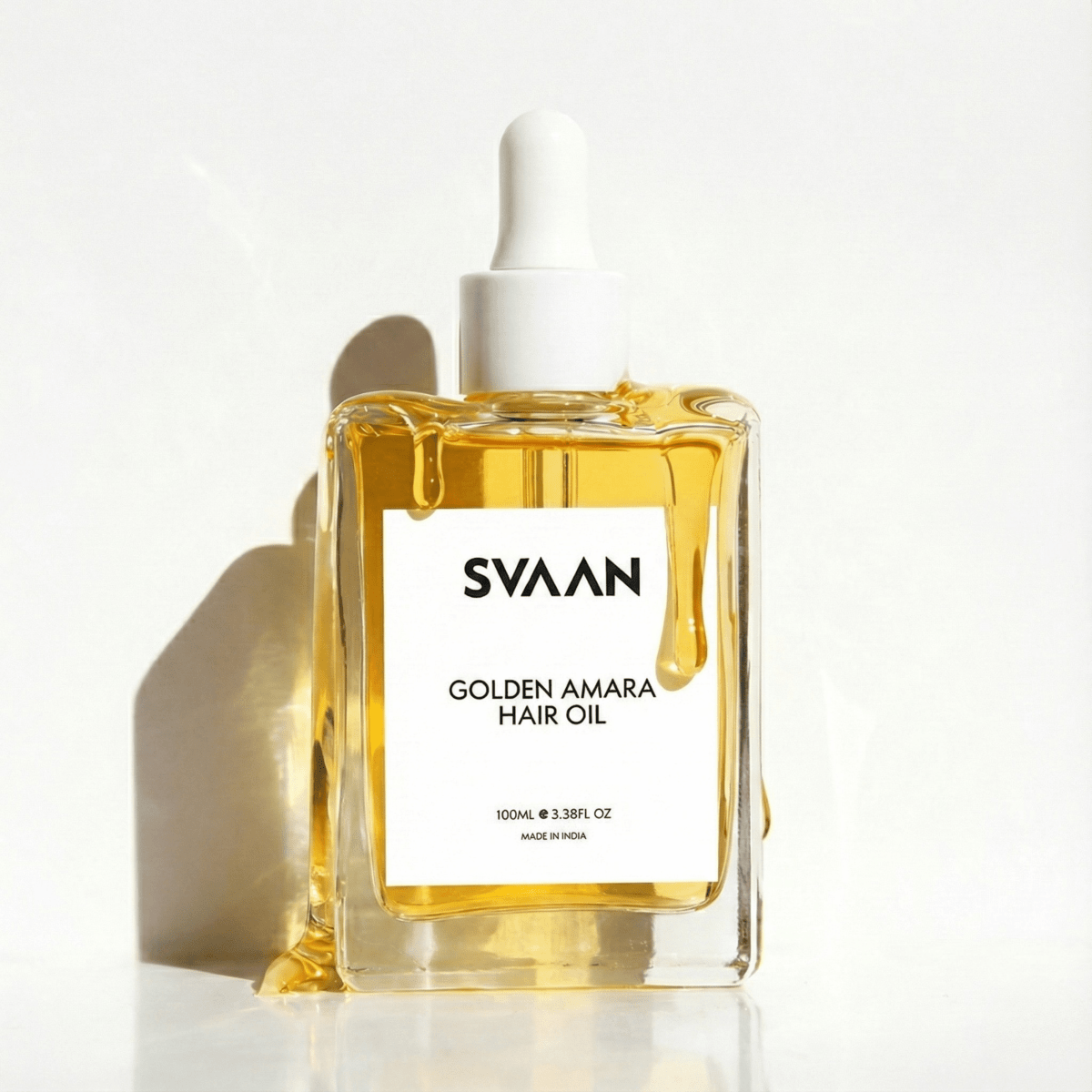 Golden Amara Hair Oil - SVAAN oil dripping from its sides shot